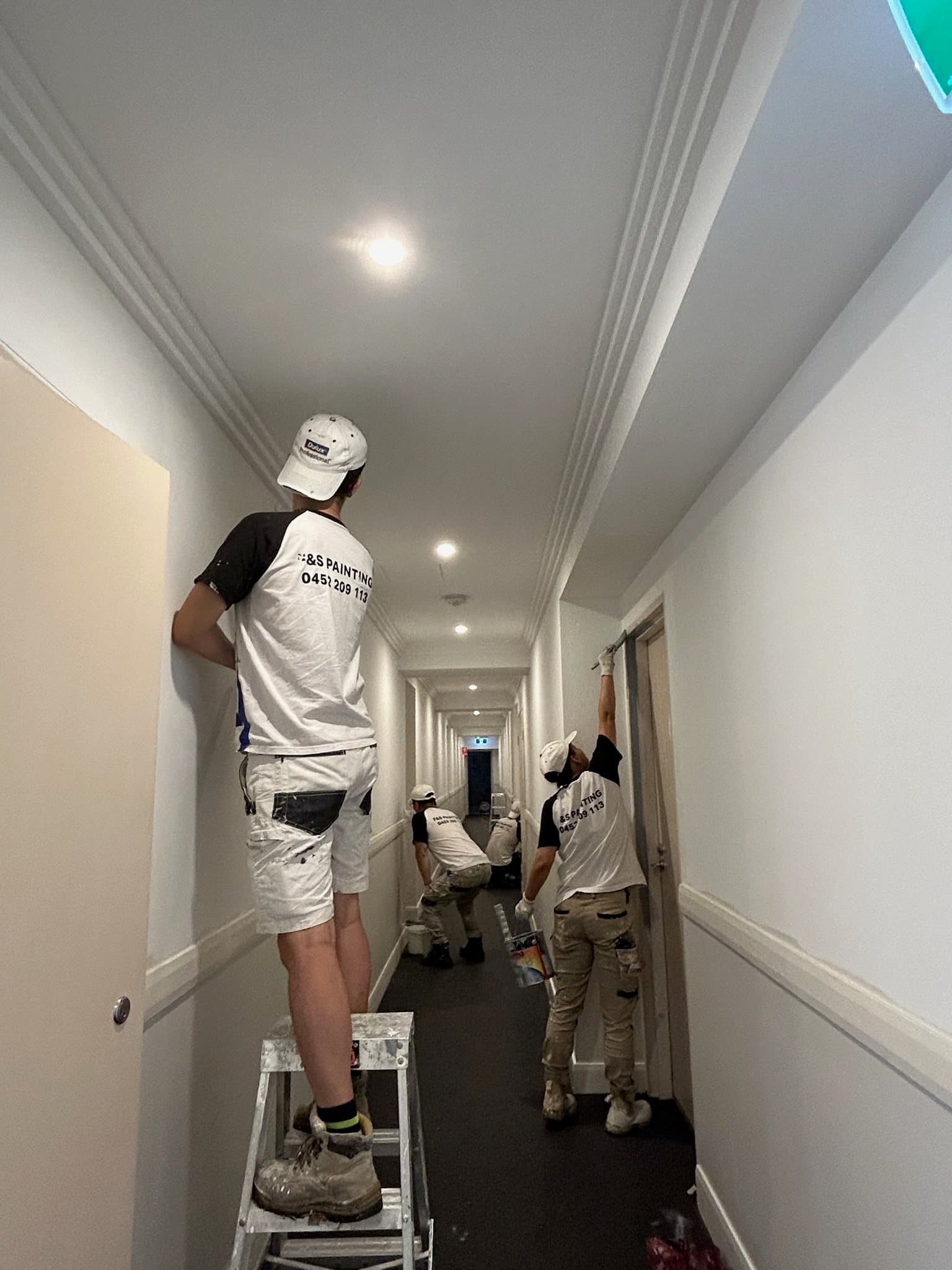 F&S Painting team repainting an interior hallway in Sydney