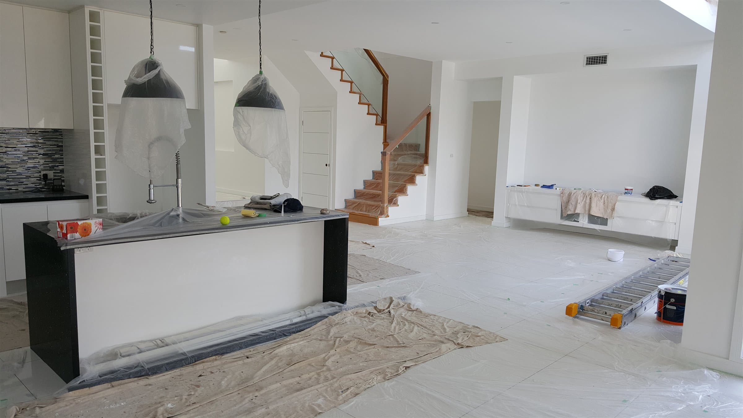 Protected interior painting work site prepared by F&S Painting