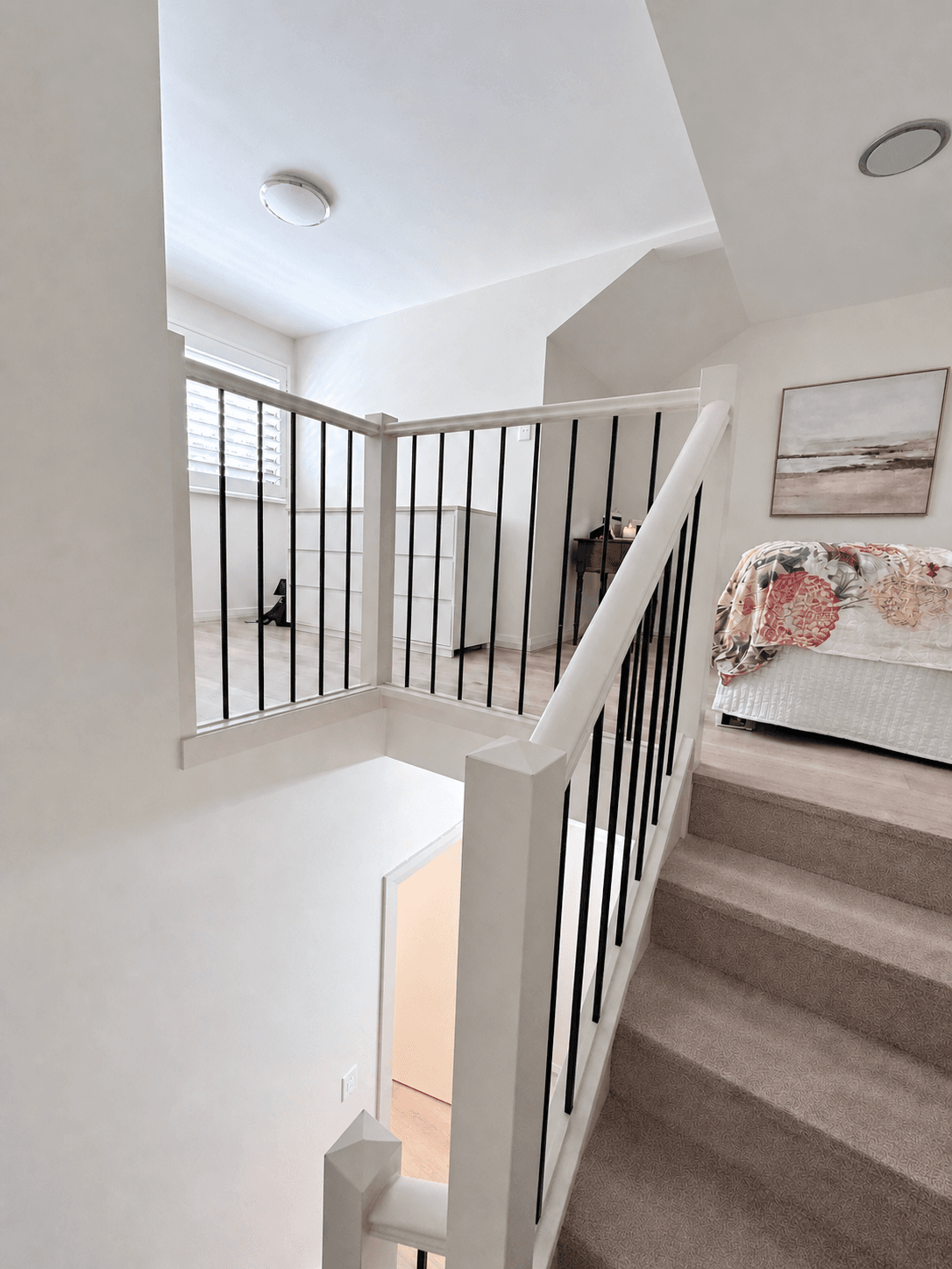 Loft-style upper bedroom and open stairwell painted by F&S Painting in Willoughby