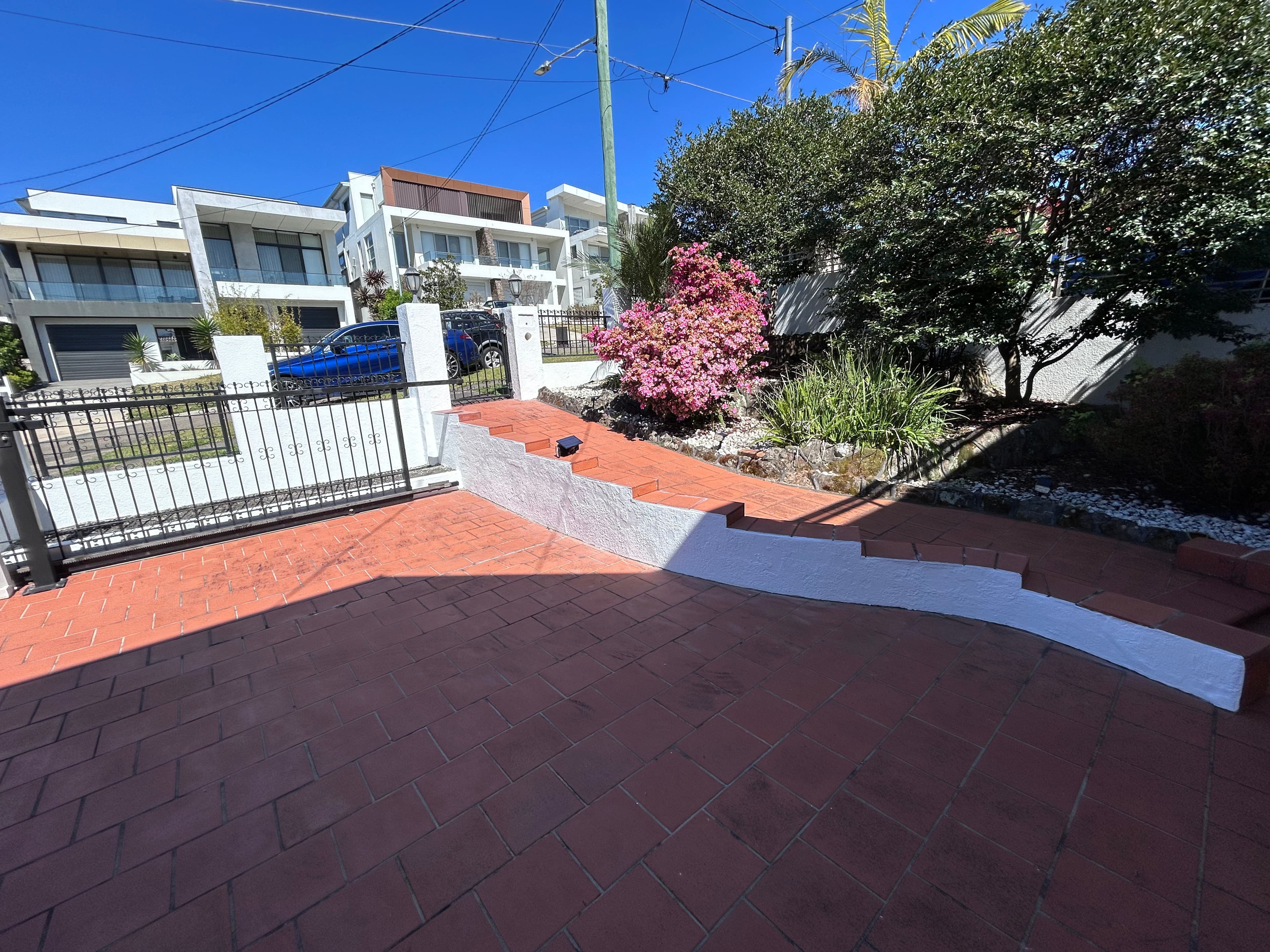 The same low retaining-wall section after repainting in Blakehurst