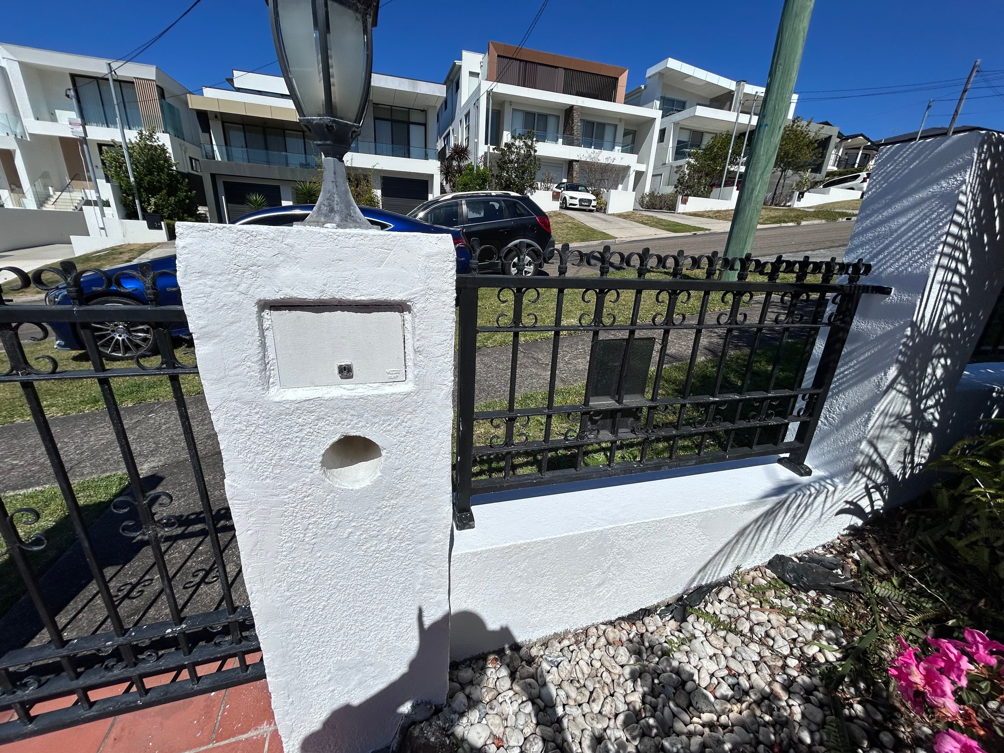 The same mailbox pillar and adjoining fence after repainting in Blakehurst