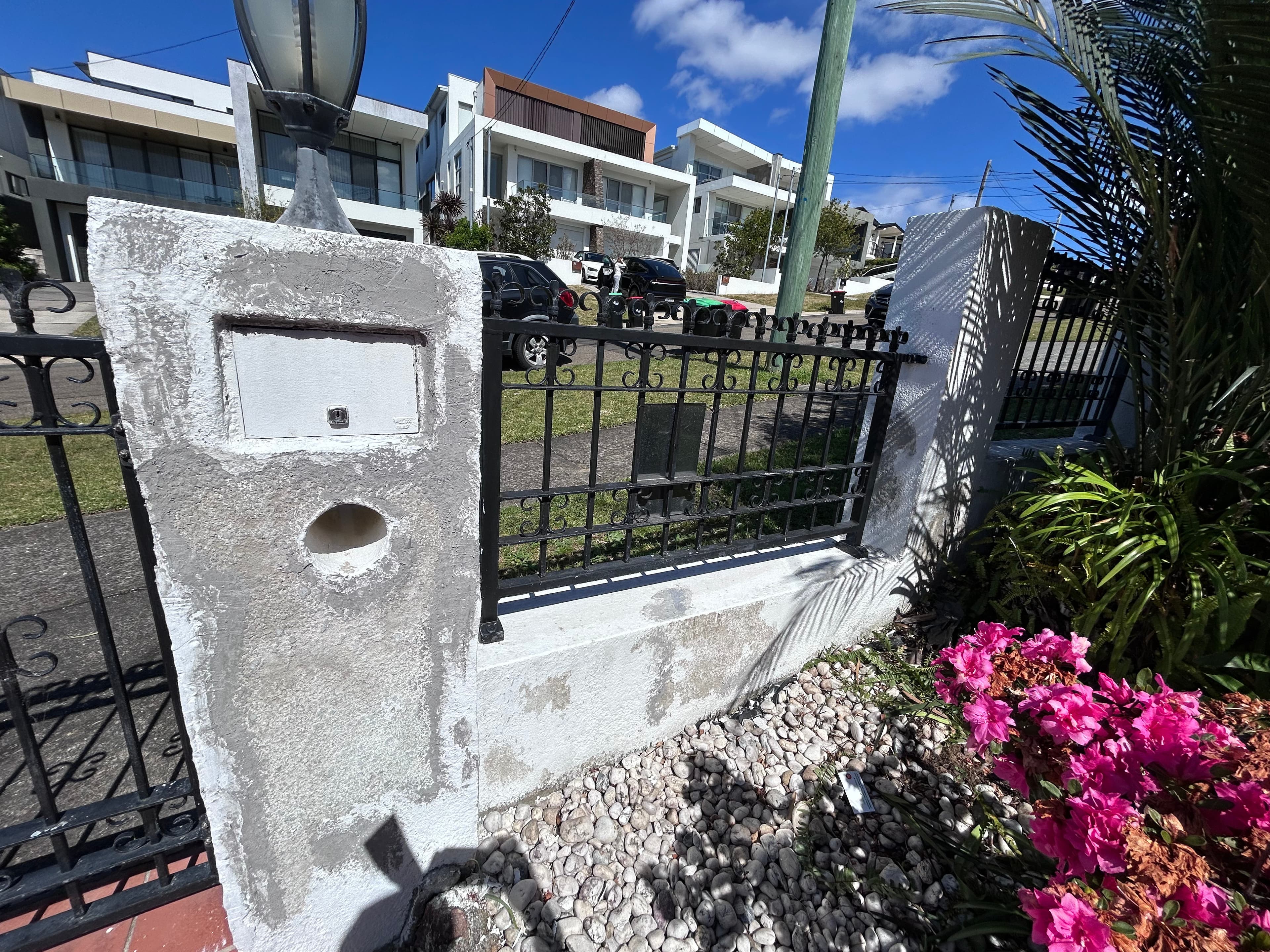 Mailbox pillar and adjoining fence before repainting in Blakehurst