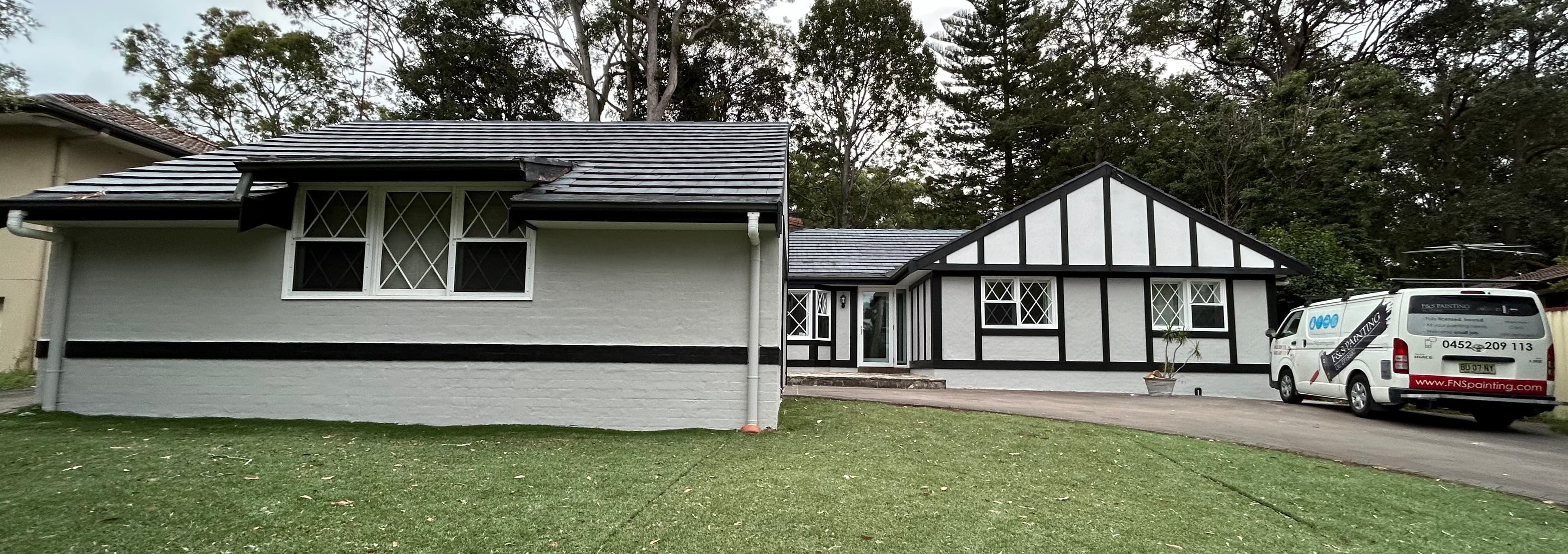 Carlingford house exterior after repainting with fresh white walls and black trim