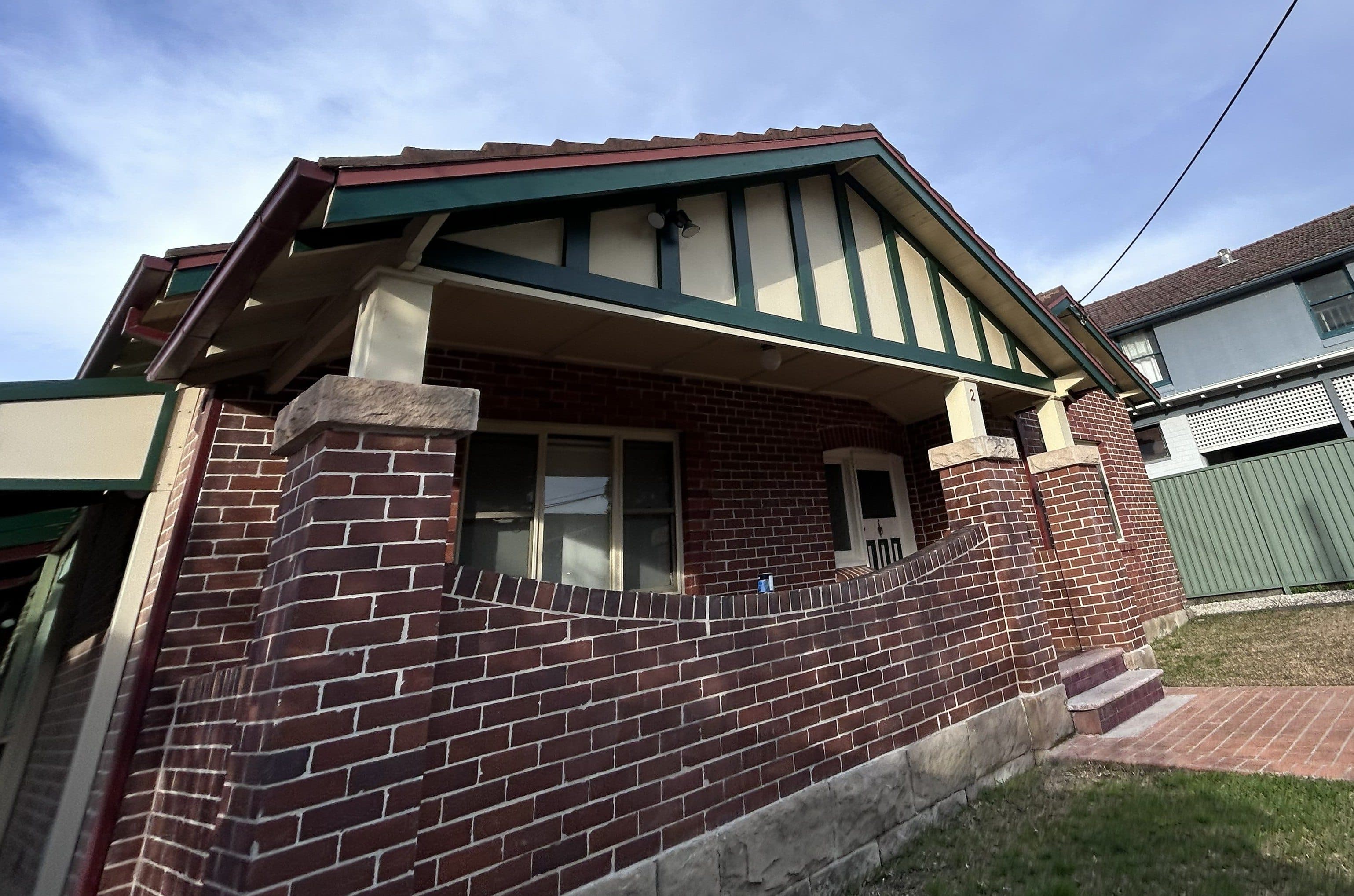 Chatswood exterior gable and trim after repainting with refreshed green and cream finishes