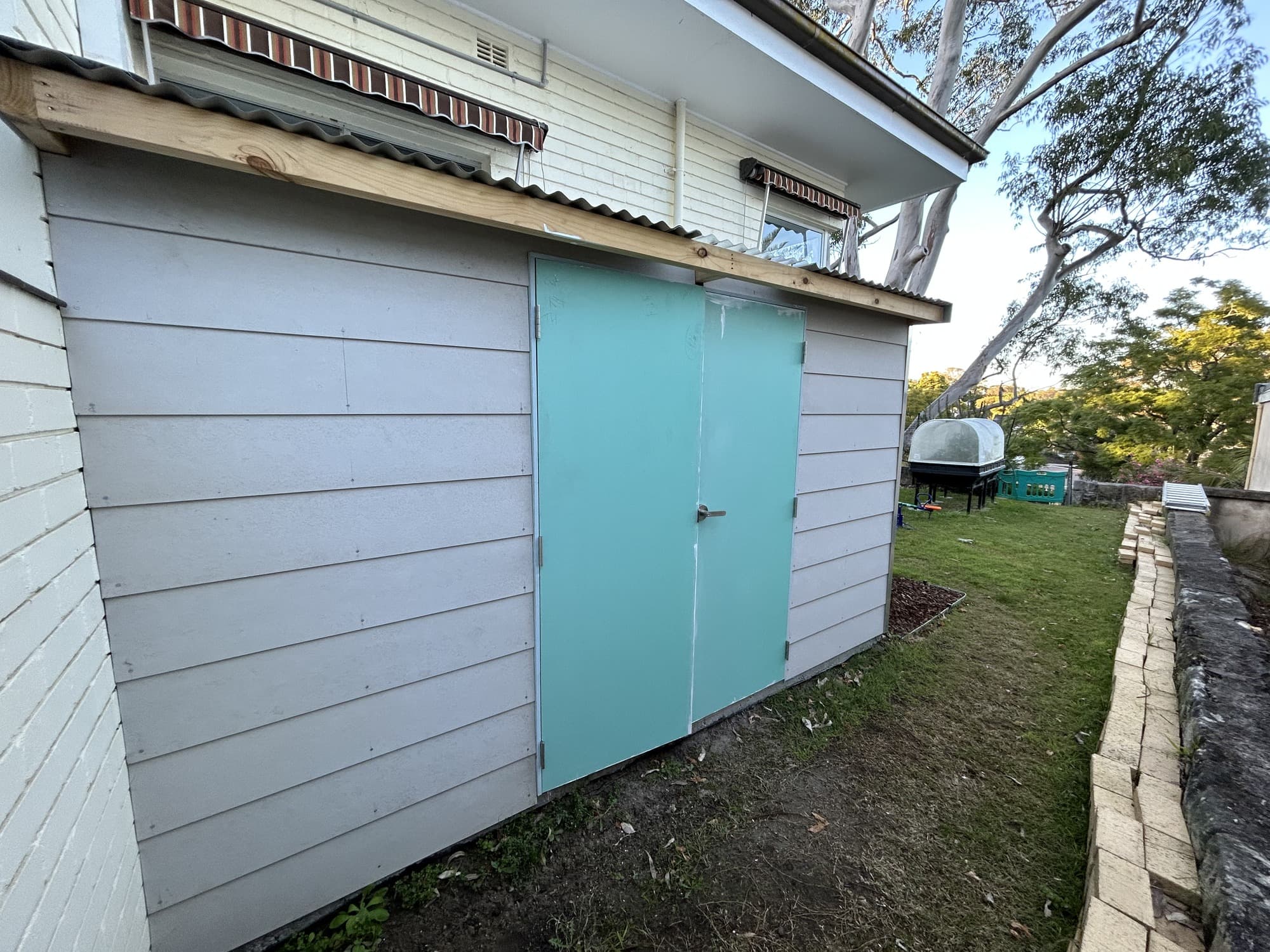 Front view of the garden shed and doors before exterior painting in Chatswood West