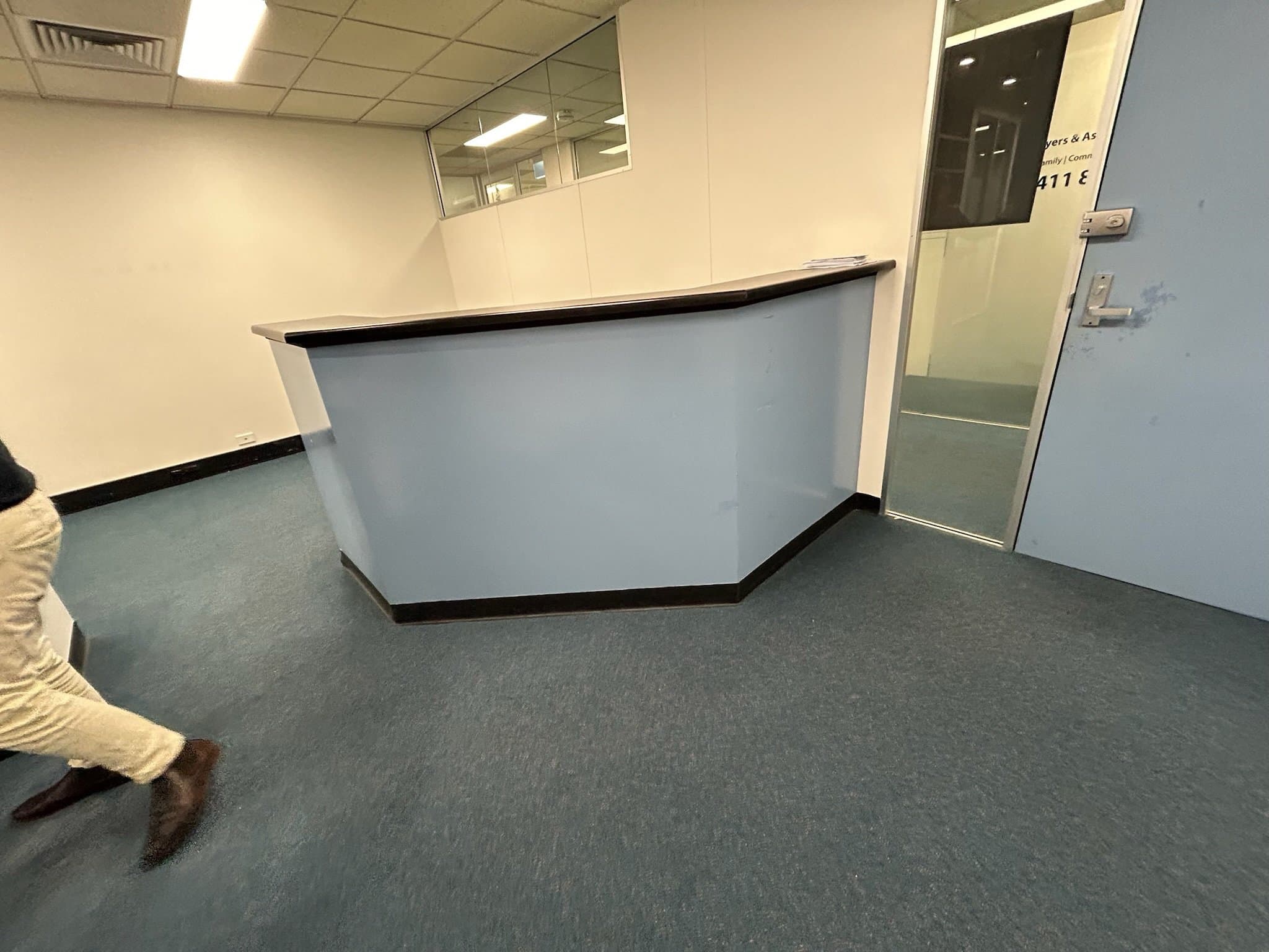 Commercial office reception area before interior repainting