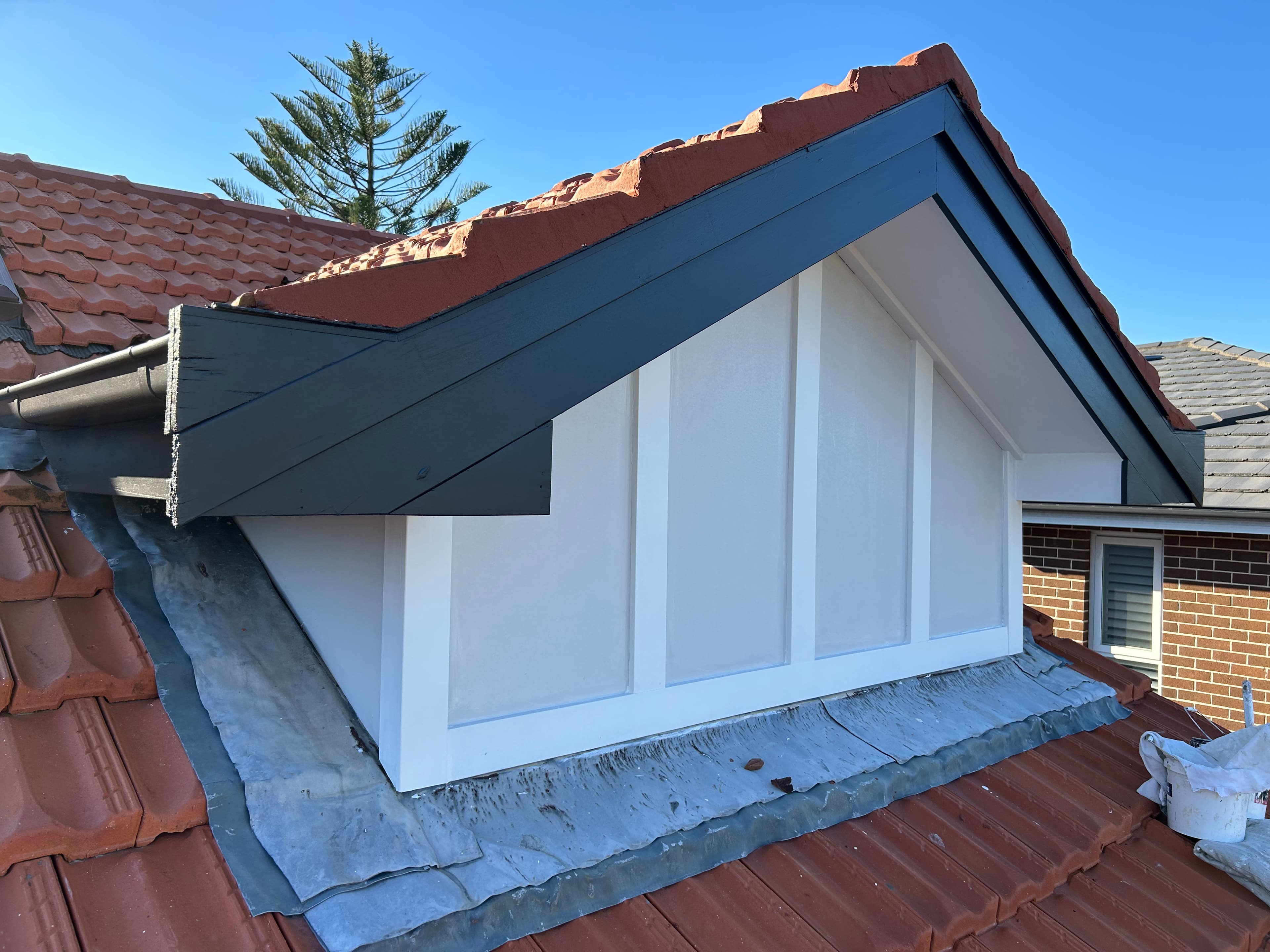 Exterior gable and roofline after repainting with fresh trim colours