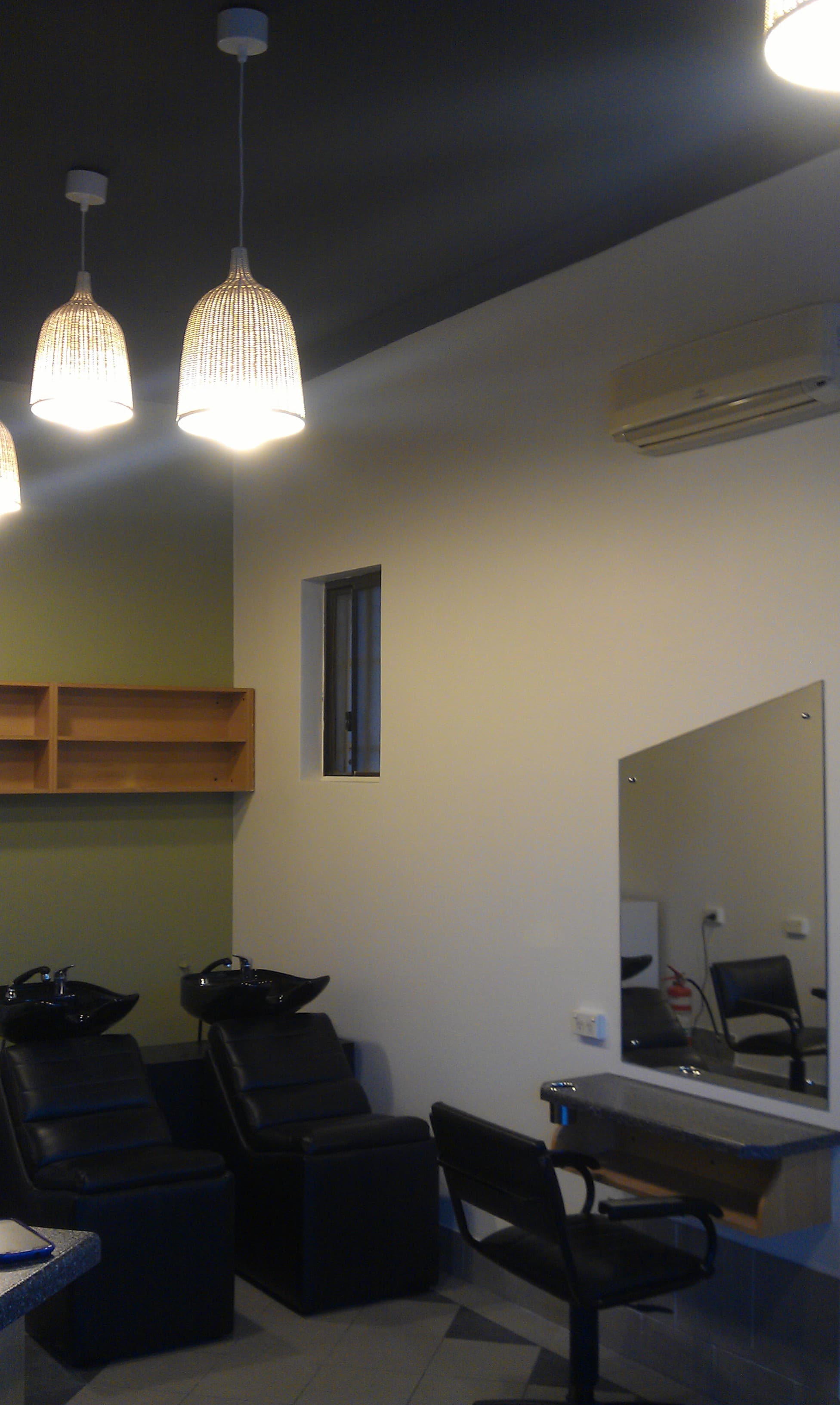 Interior feature wall and ceiling after repainting with a darker ceiling finish