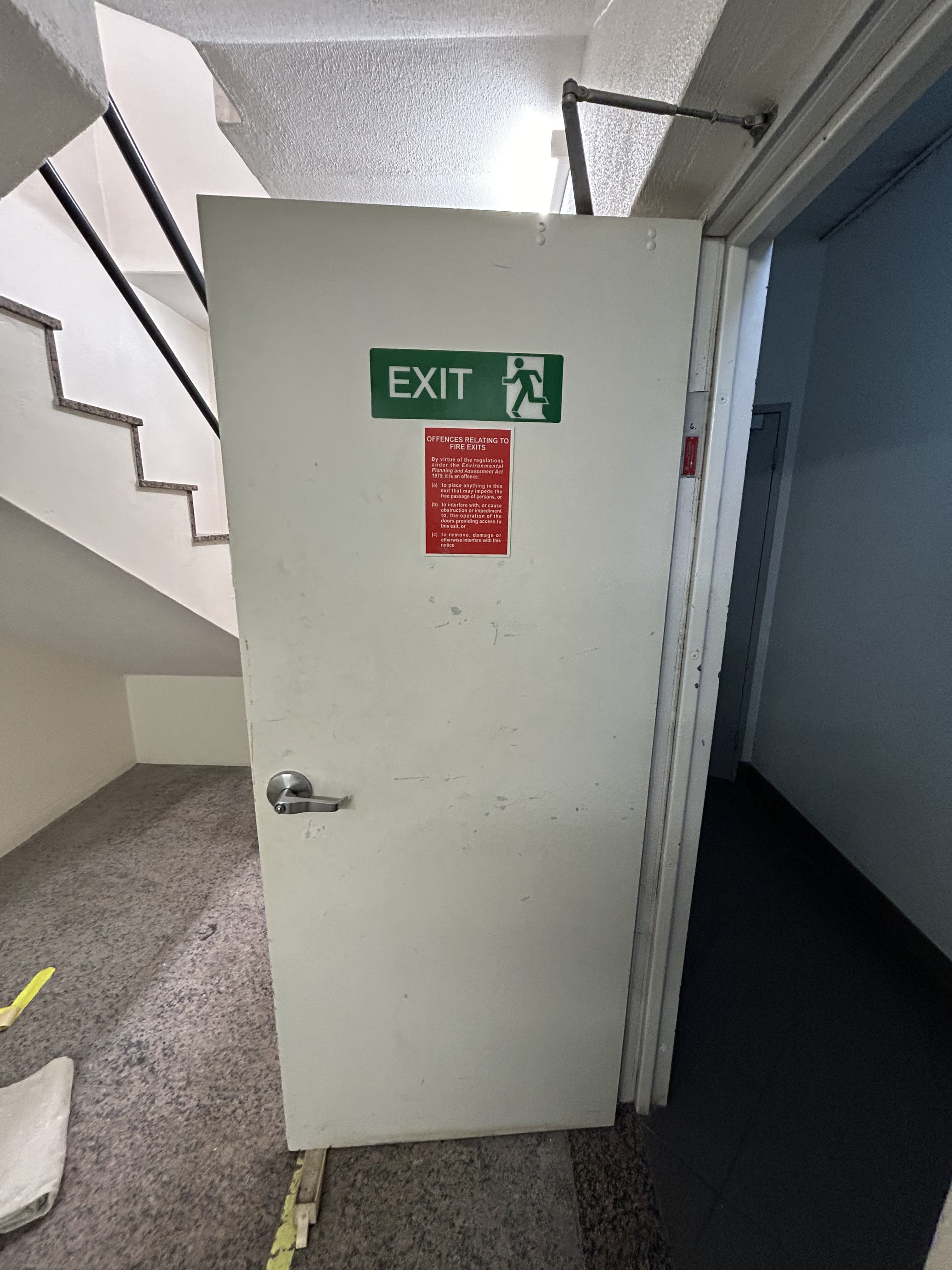 Commercial fire exit door before repainting in Sydney