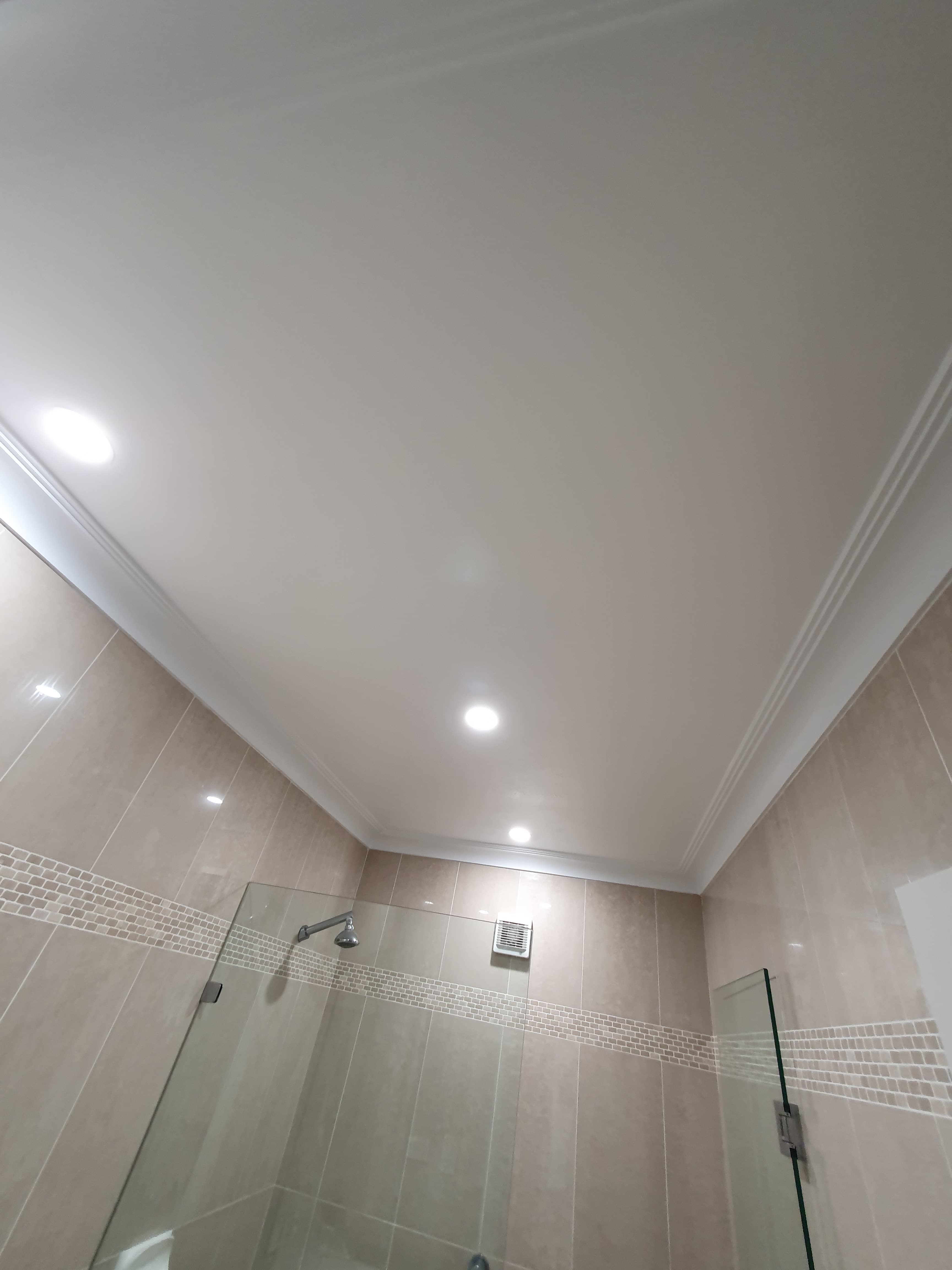 Bathroom ceiling restored with a smooth clean repaint after mould damage