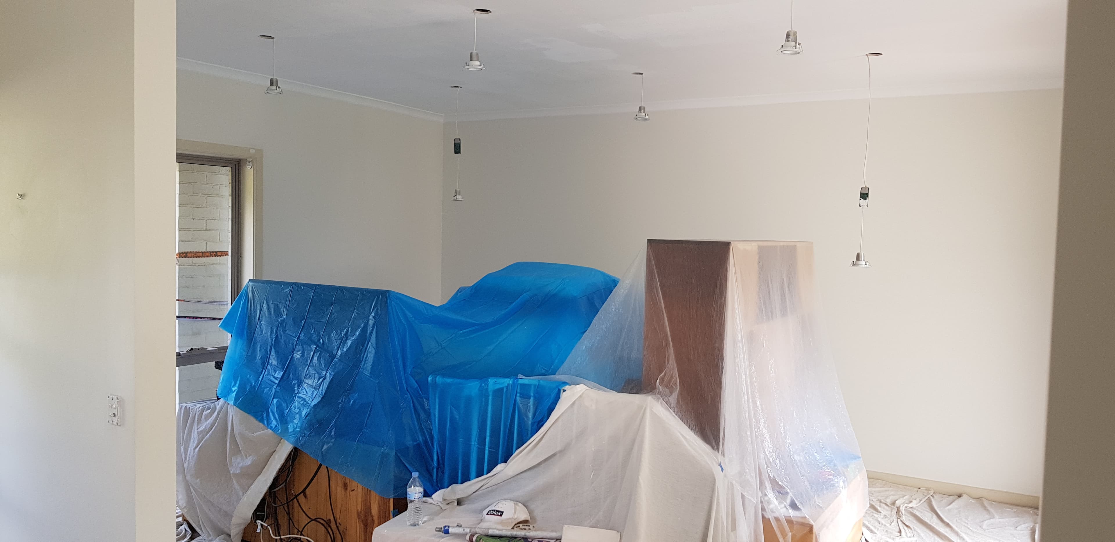 Newington living area before interior repainting with furniture and floors protected
