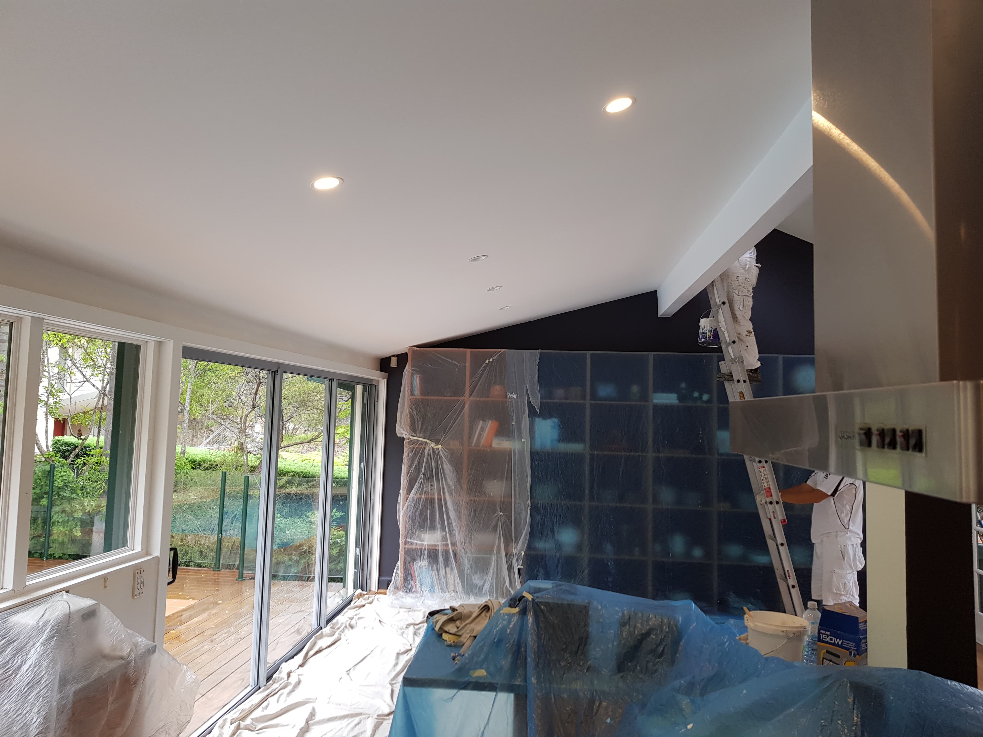 North Bridge interior living and kitchen area before repainting with surfaces protected