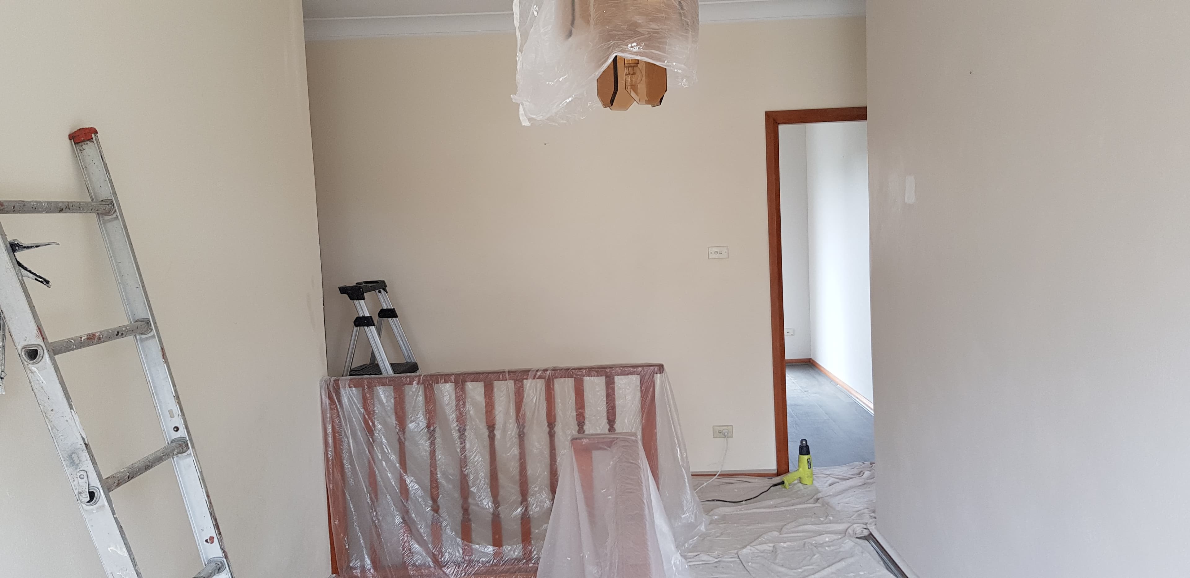 North Ryde interior walls before repainting with floors and timber railing protected