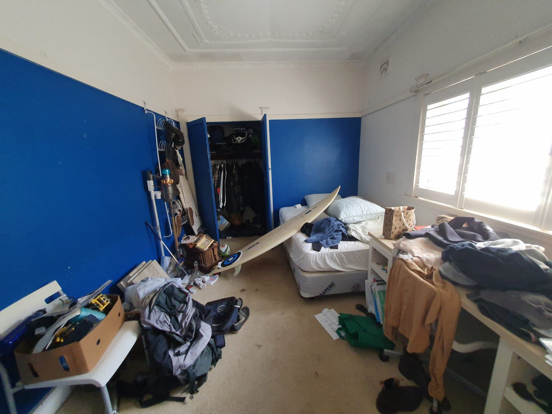 Roseville bedroom before repainting with blue feature walls and furniture in the room