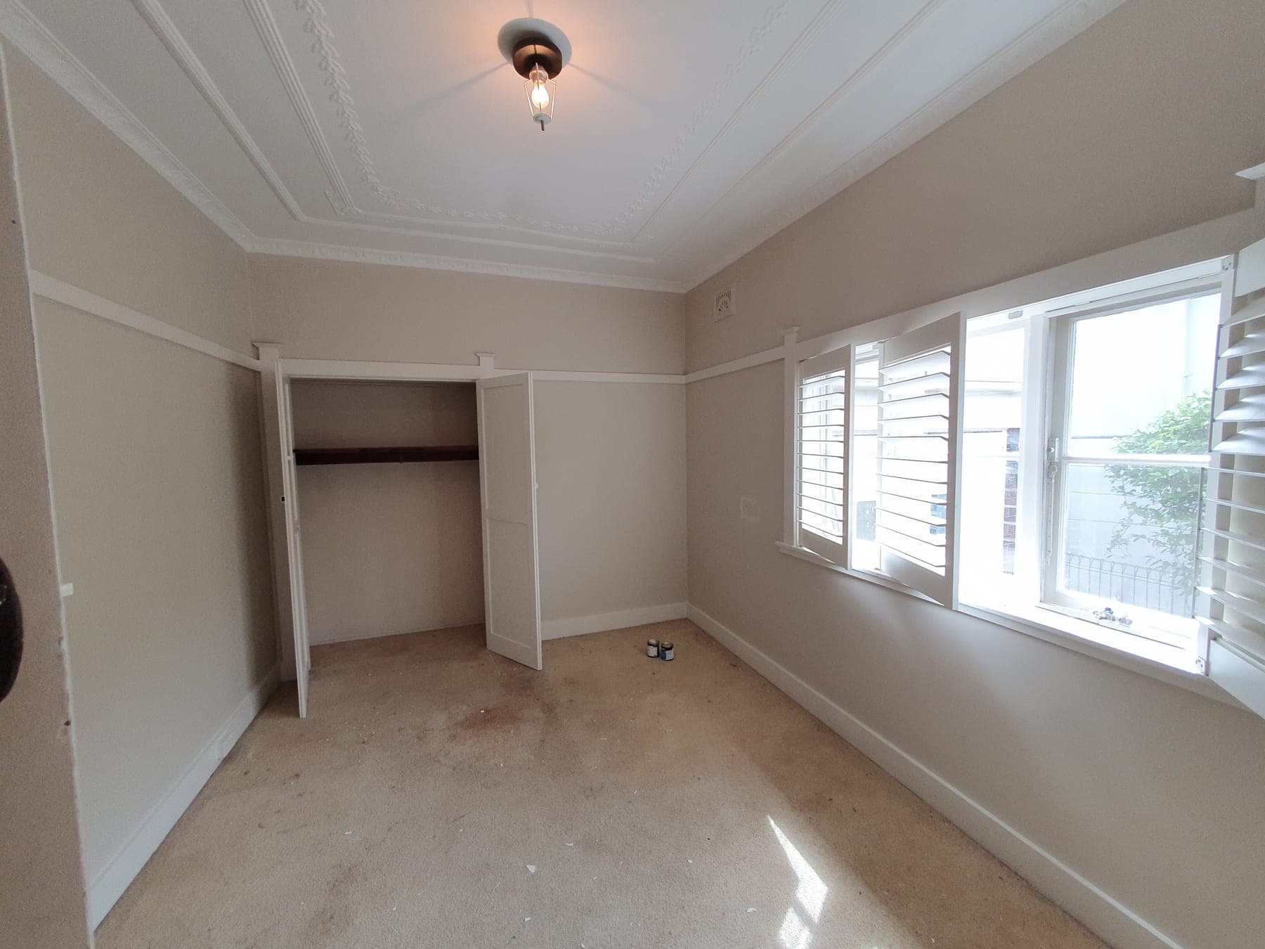 Roseville bedroom after repainting with neutral walls, white trim, and a cleaner finish