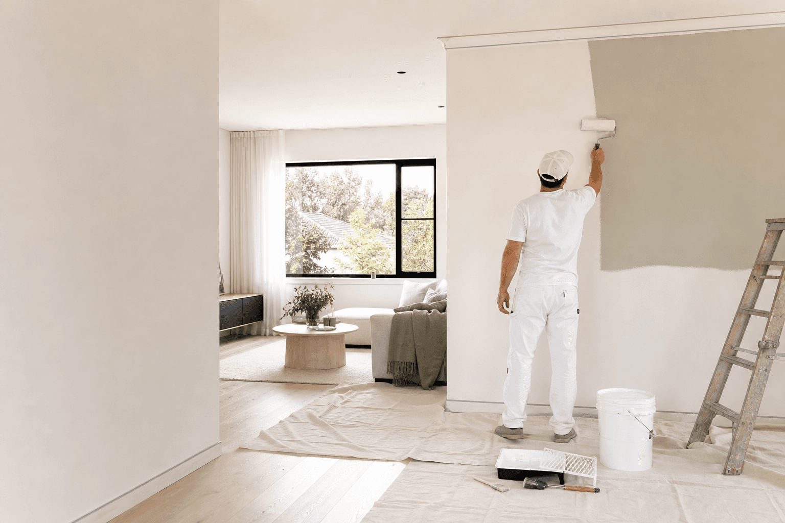 Professional painter applying fresh interior paint in a Sydney home