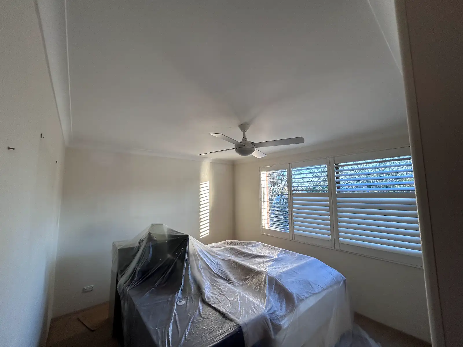 Chatswood apartment bedroom protected during wall and ceiling repainting