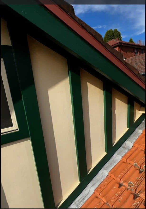 Chatswood exterior gable detail after green trim and cream panel repainting