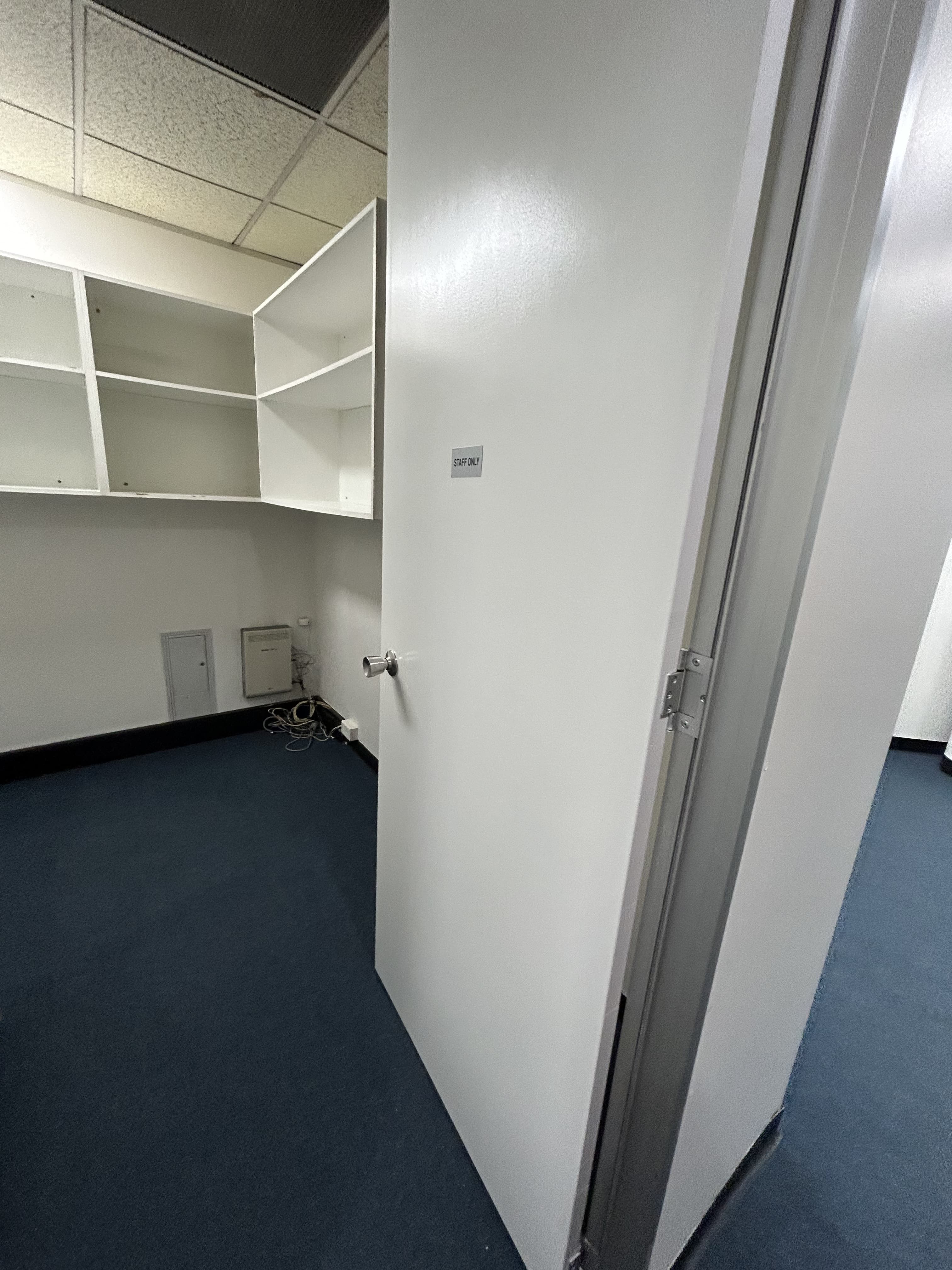 Chatswood office storage room and shelving area after painting