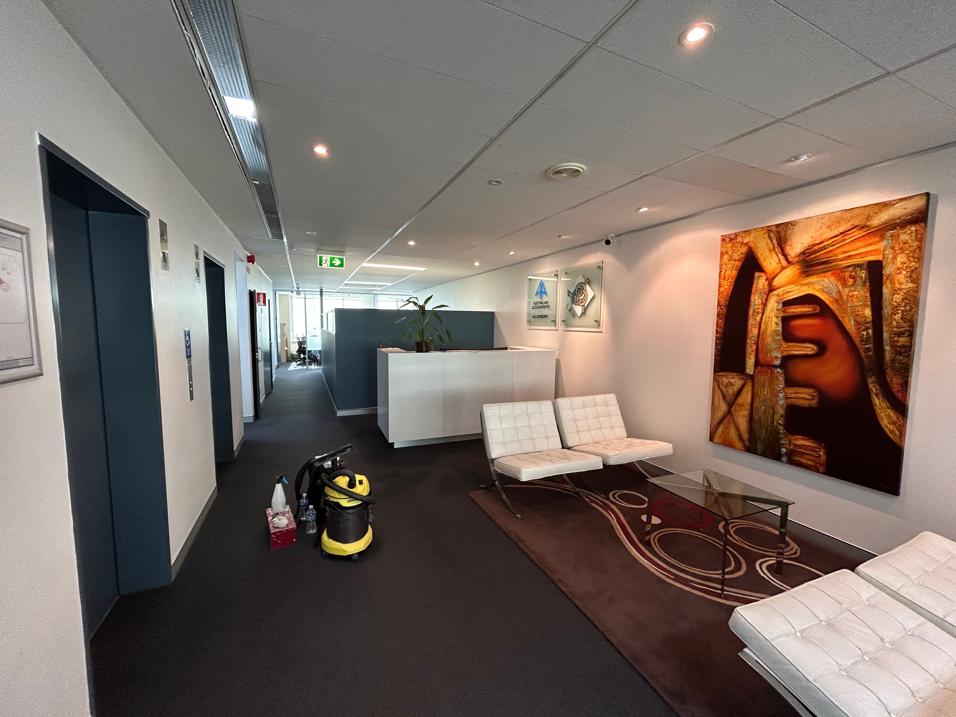 Chatswood office lobby and lift-side seating area after commercial painting