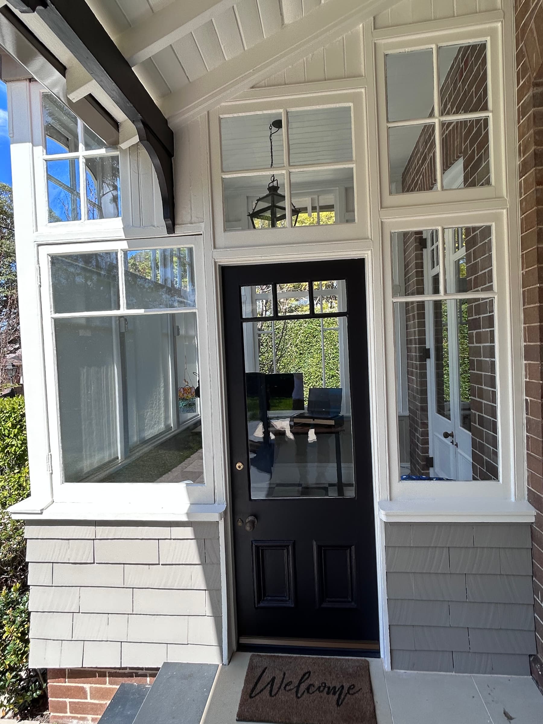 Completed white timber window joinery beside a Chatswood entry