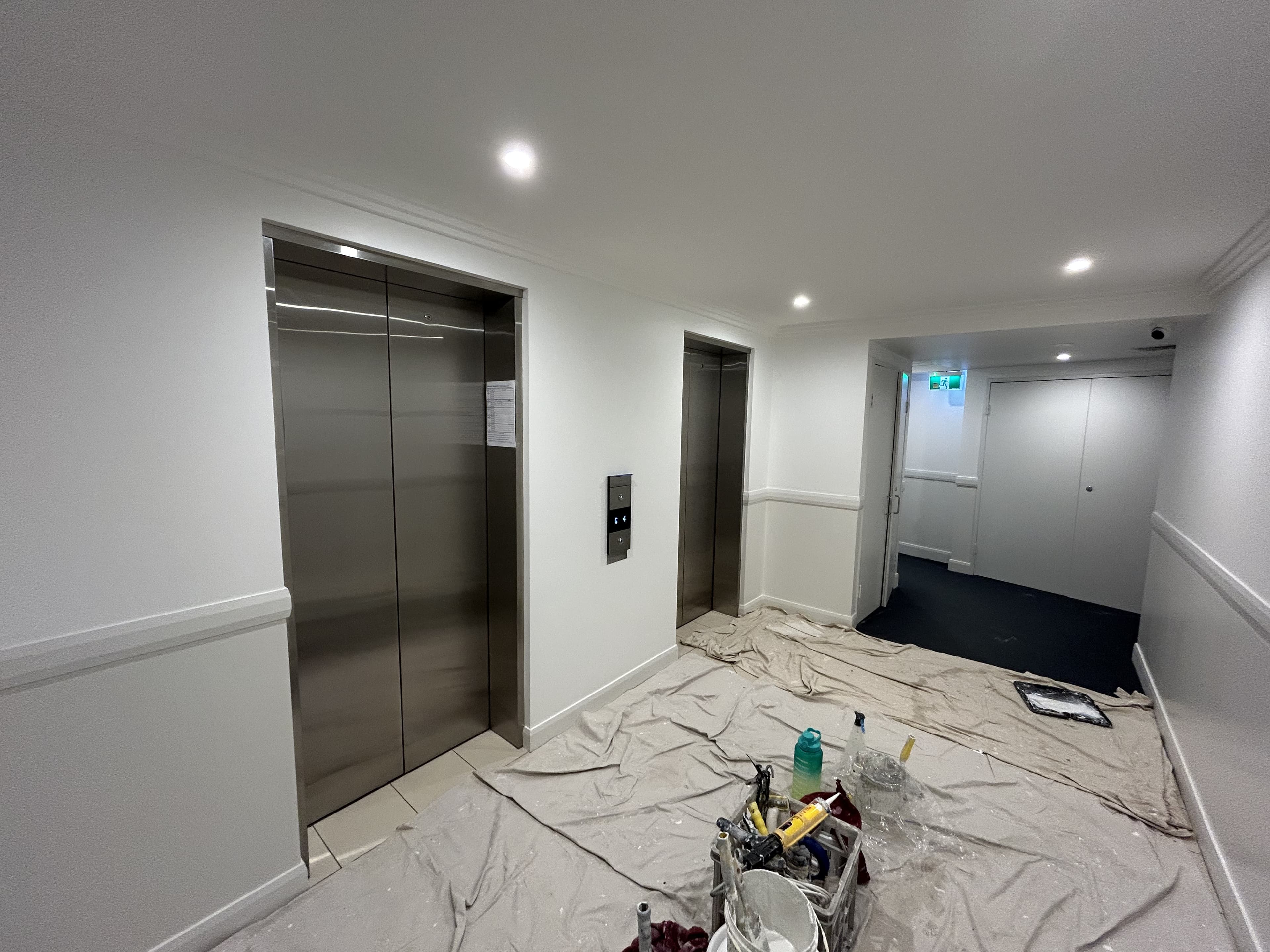 Dee Why strata lift lobby during repainting with protected floors and fresh wall finish