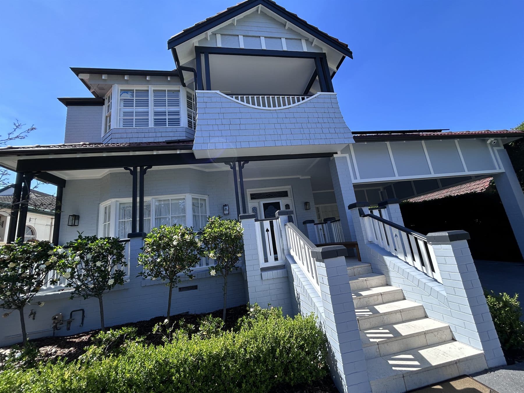 East Lindfield front entry, balcony, stairs, railings, and facade after repainting