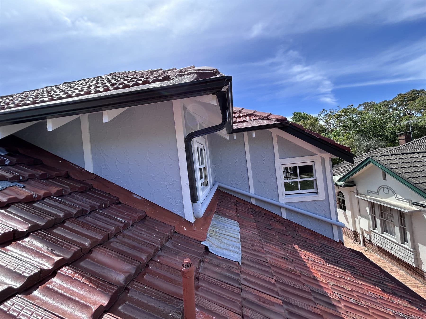 East Lindfield upper roofline, gutters, and gable trim after exterior painting