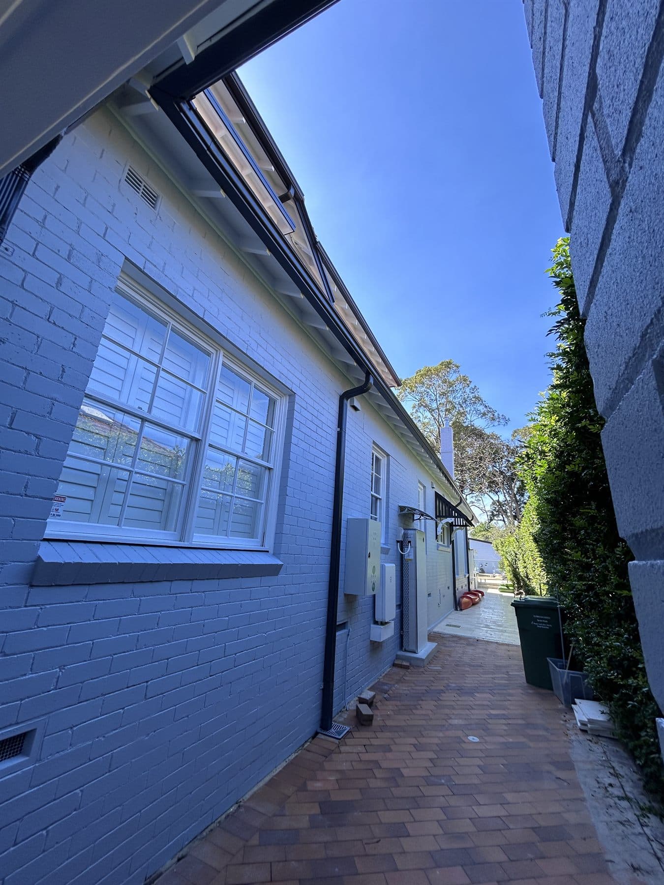 East Lindfield side elevation after exterior painting with white walls and dark gutters