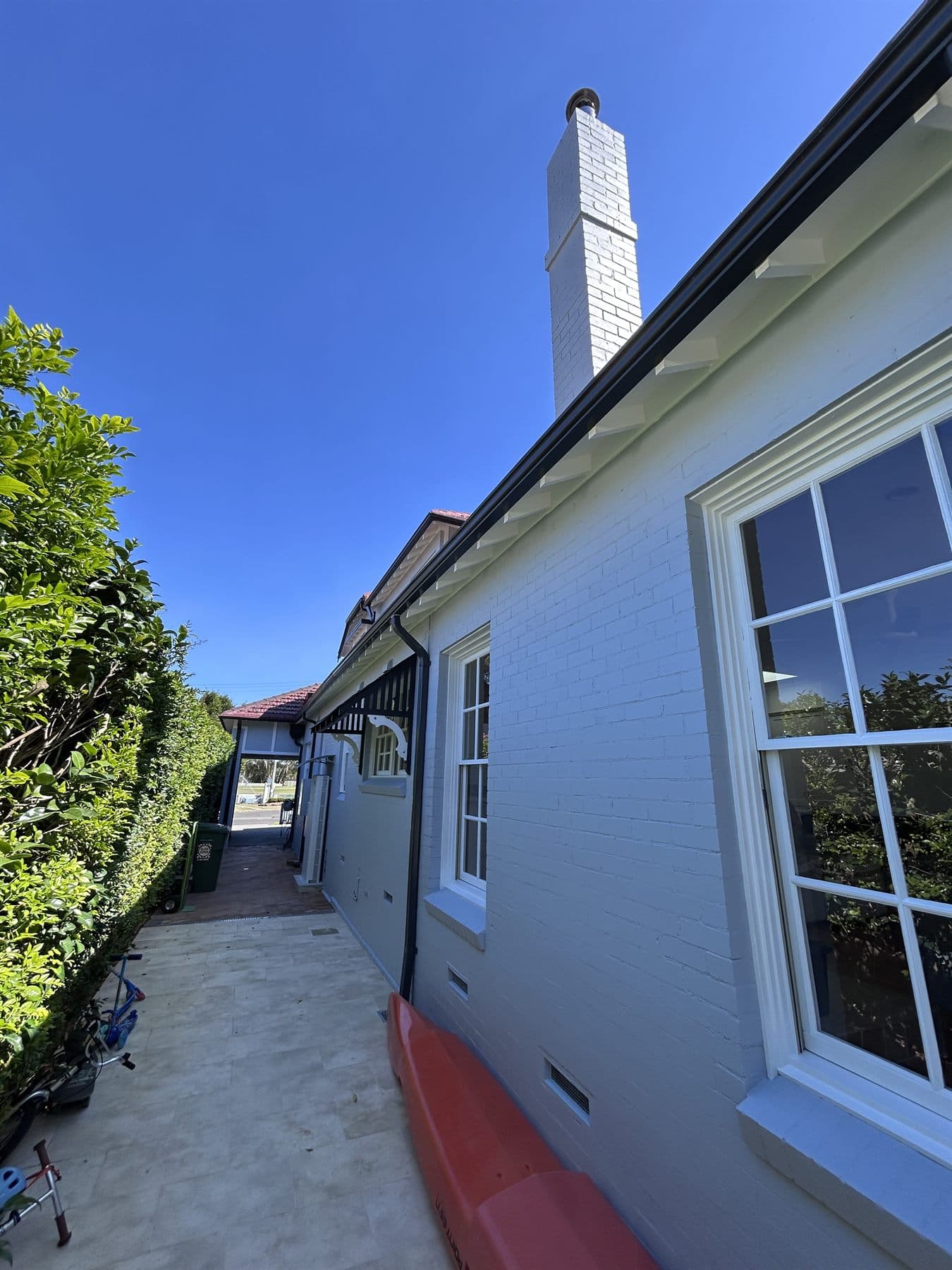 East Lindfield side wall, chimney, windows, gutters, and eaves after repainting