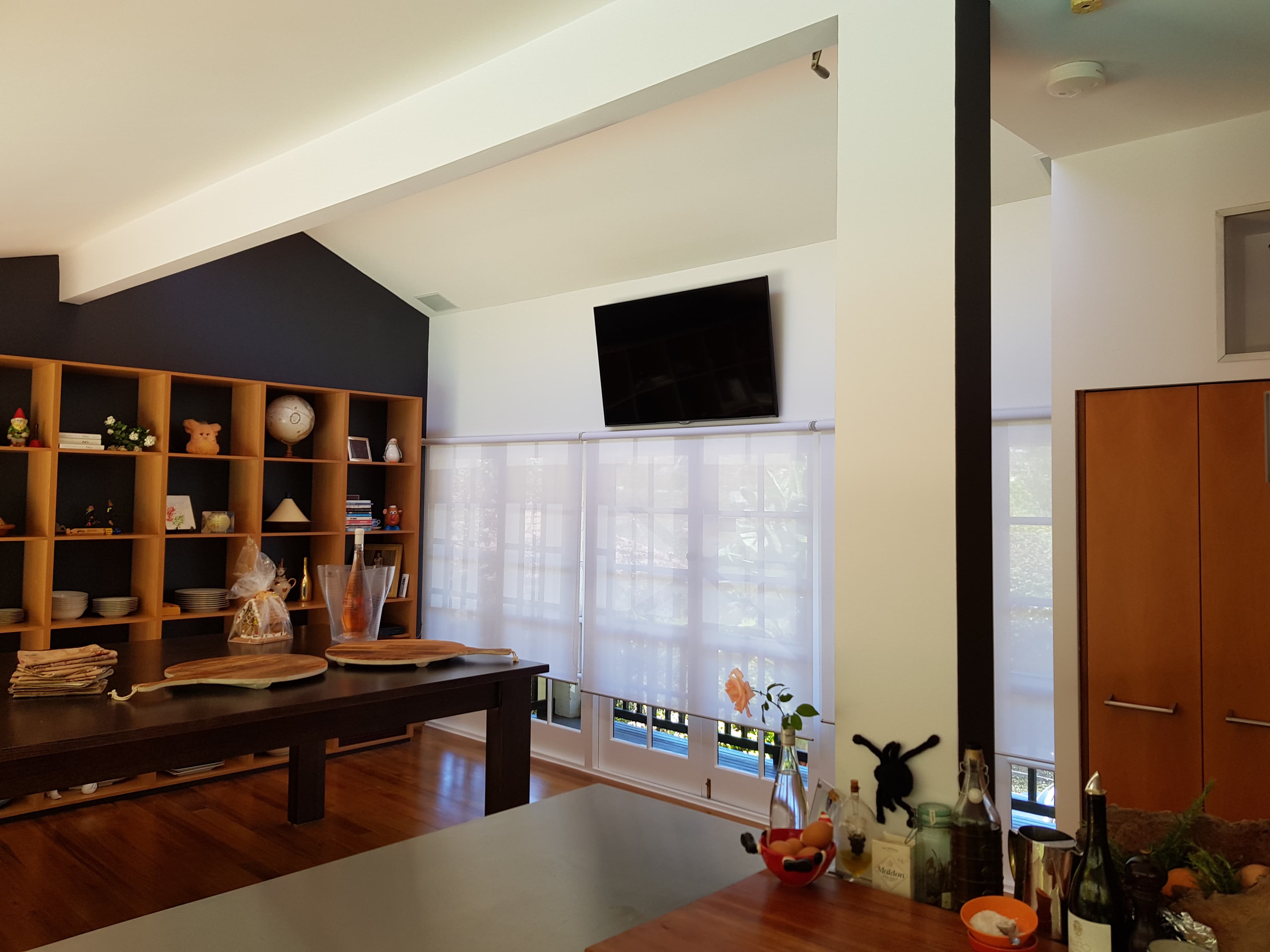 North Bridge dining area after interior painting with dark feature wall and timber floors