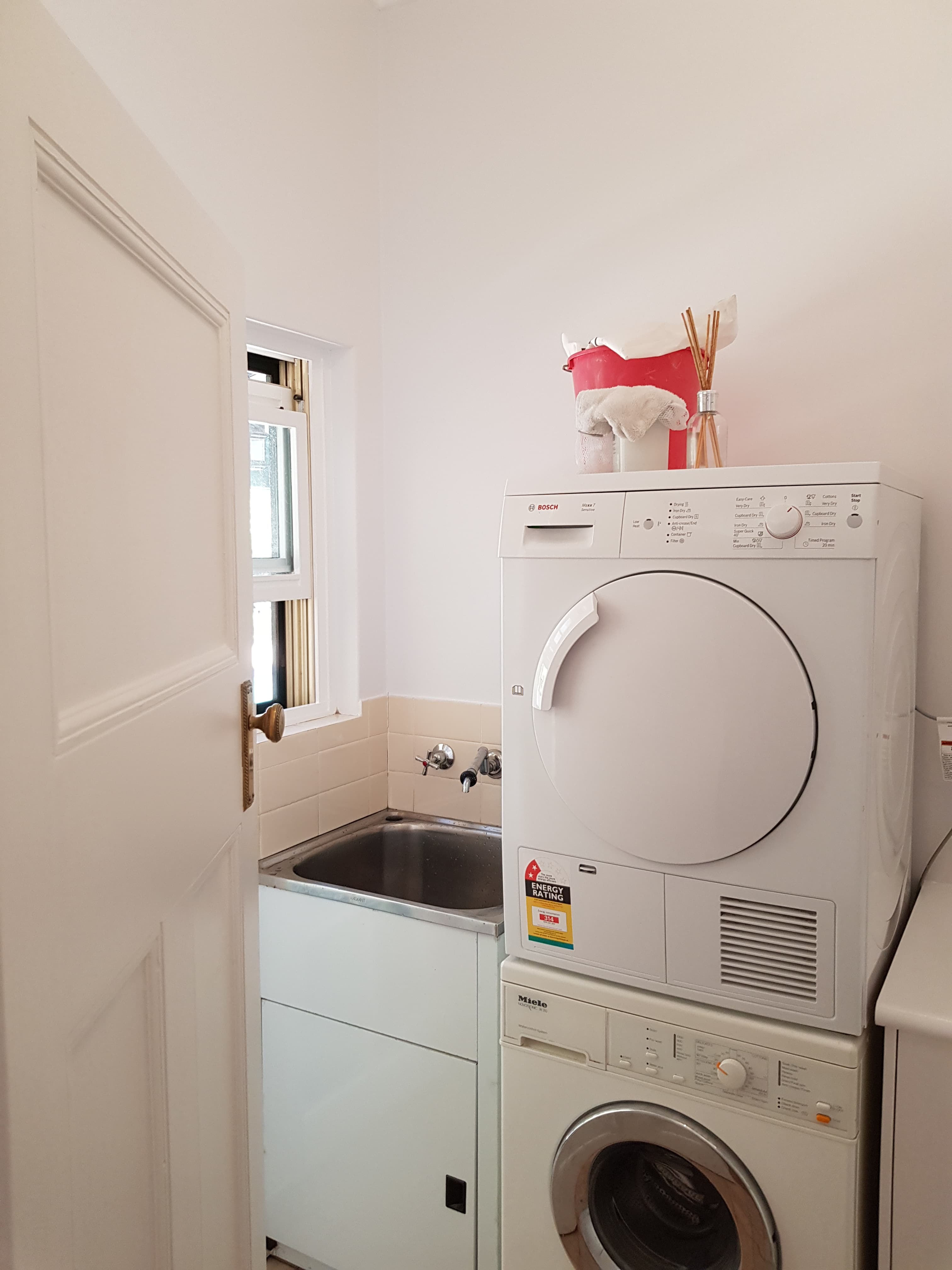 North Bridge laundry after interior repainting with clean white walls and trim