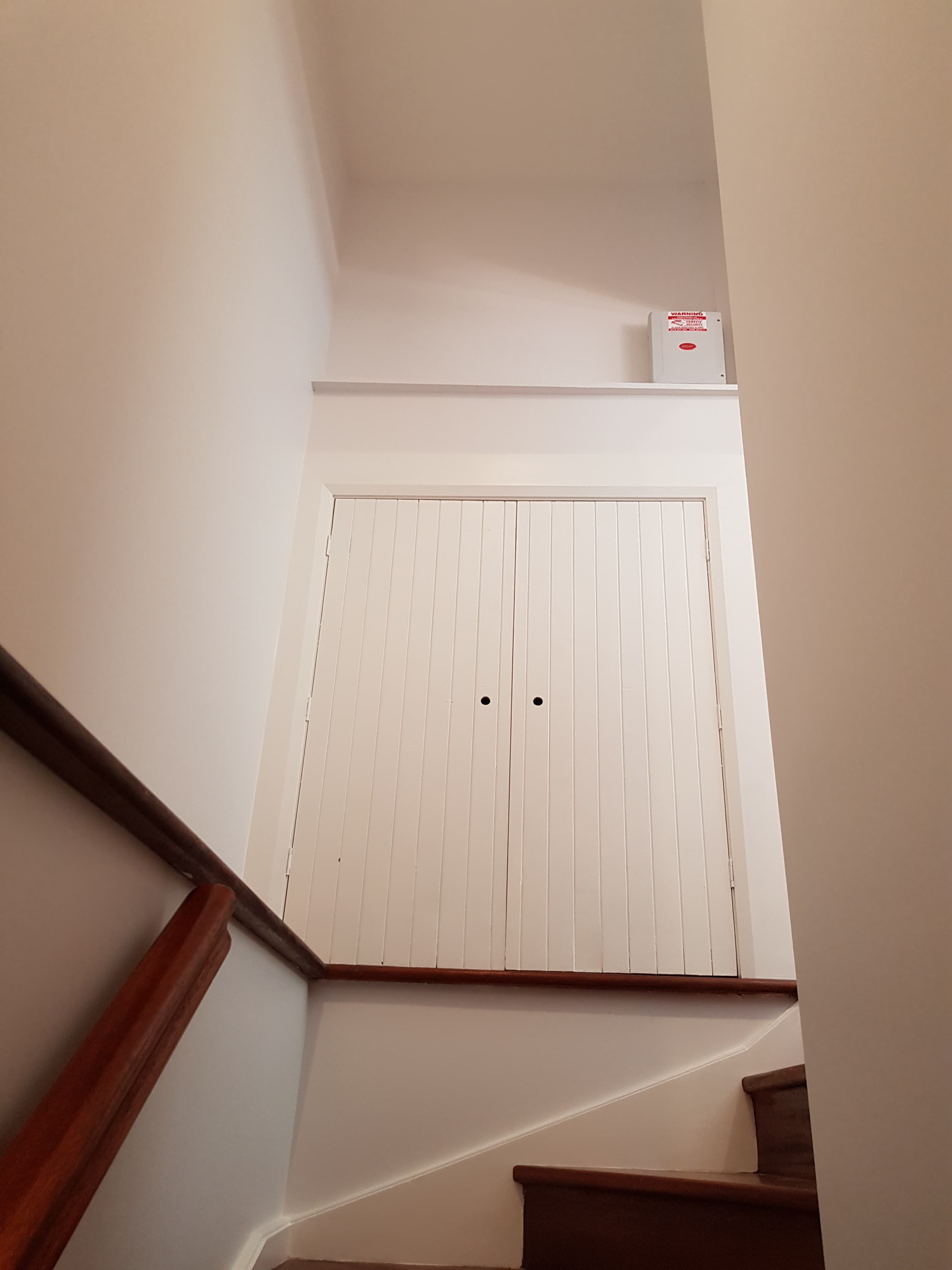 North Bridge stairwell after repainting with clean walls and timber stair details