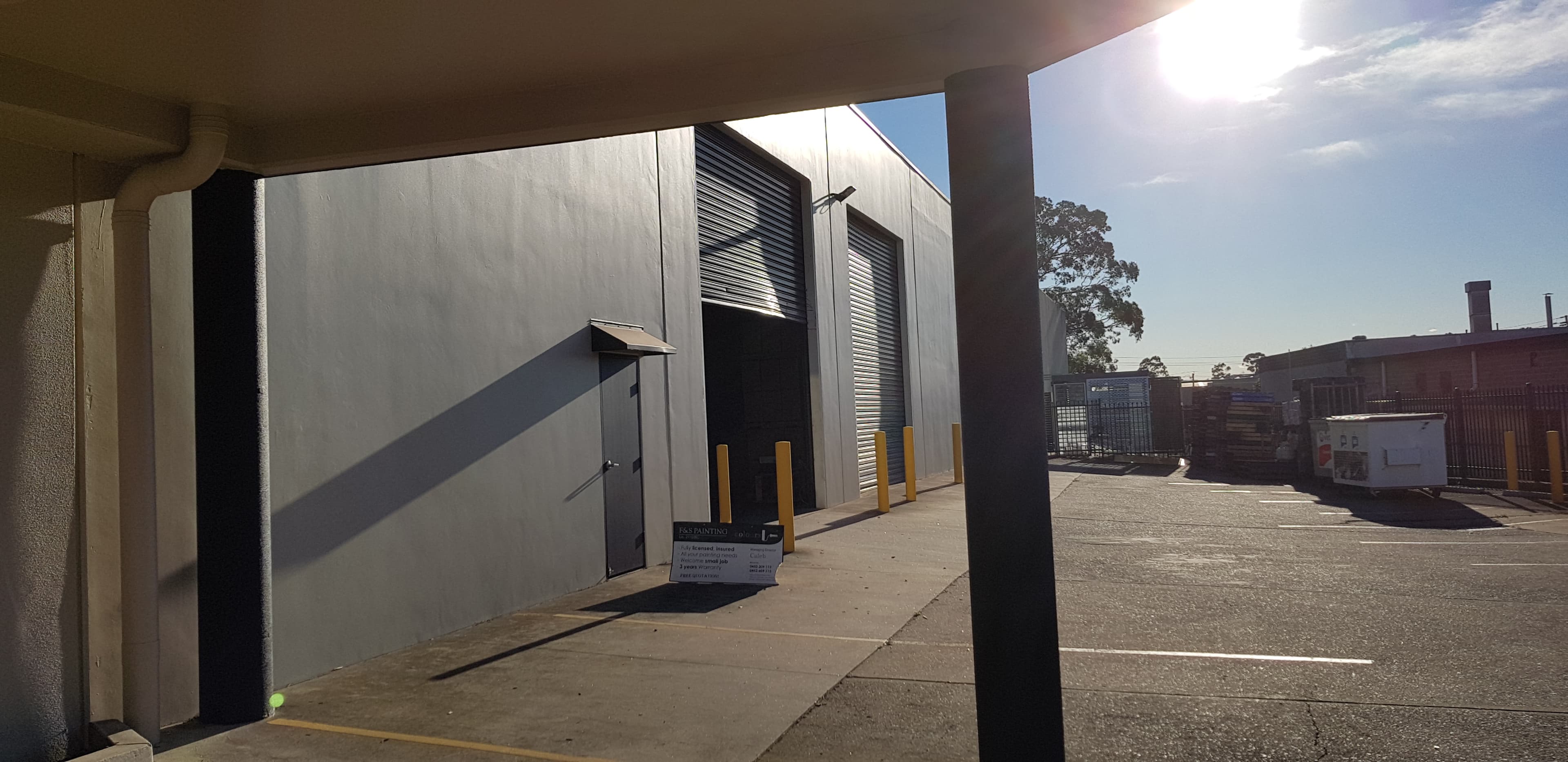 Wetherill Park commercial side driveway wall and roller doors after painting